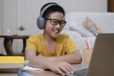 Asian boy enjoy self study with e-learning at home.